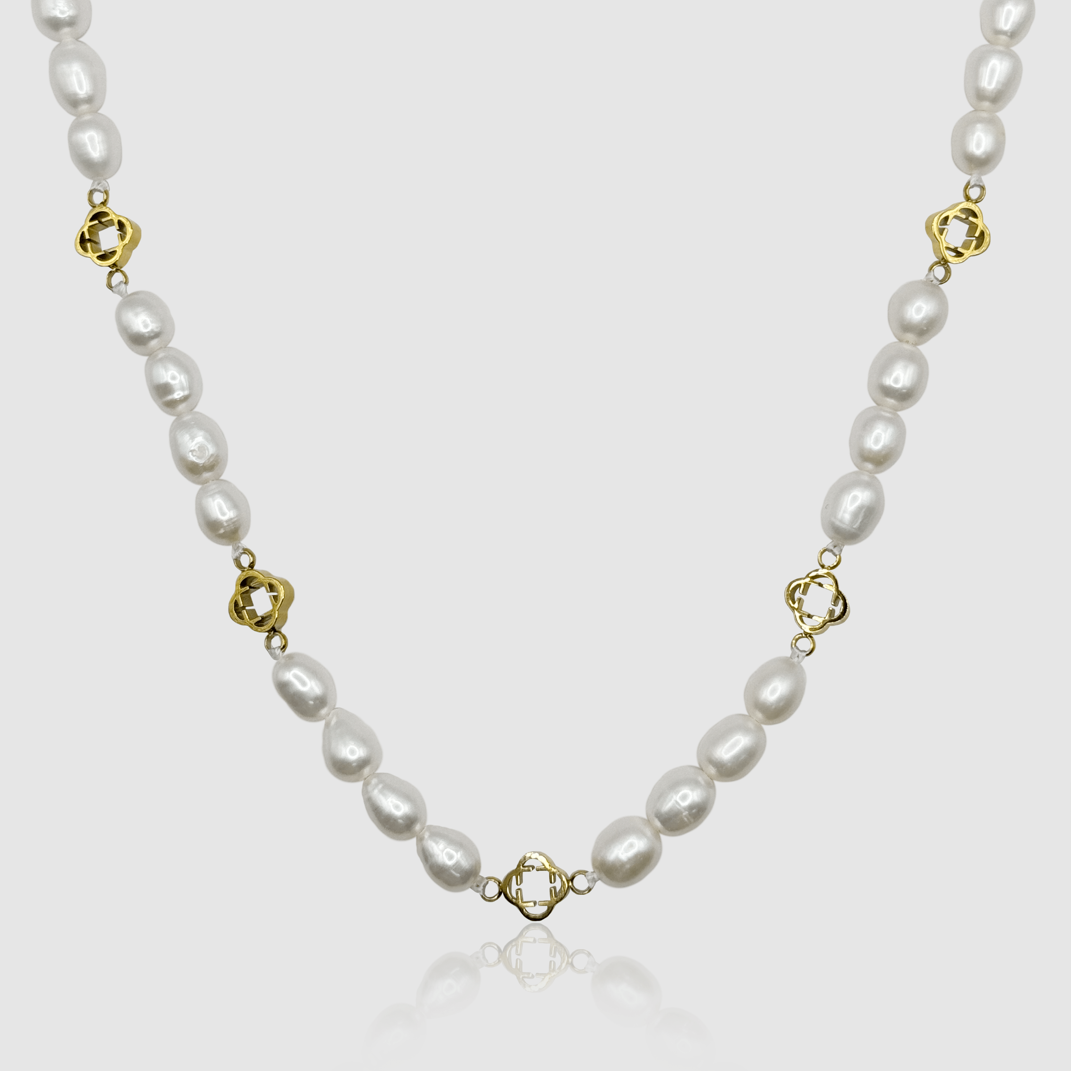 Classic white pearl necklace adorned with luxurious gold details, a timeless accessory for any man's wardrobe.
